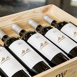 Asymmetrical shot of wooden box filled with wine